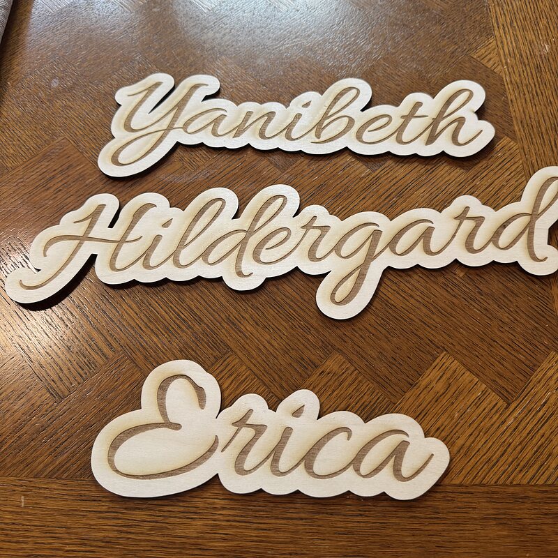Yanibeth, Hildergard and Erica: script names engraved and cut out of basswood