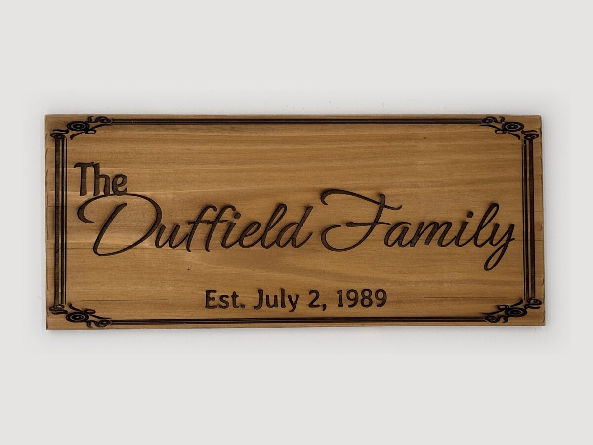 The Duffield Family sign engraved in cedar