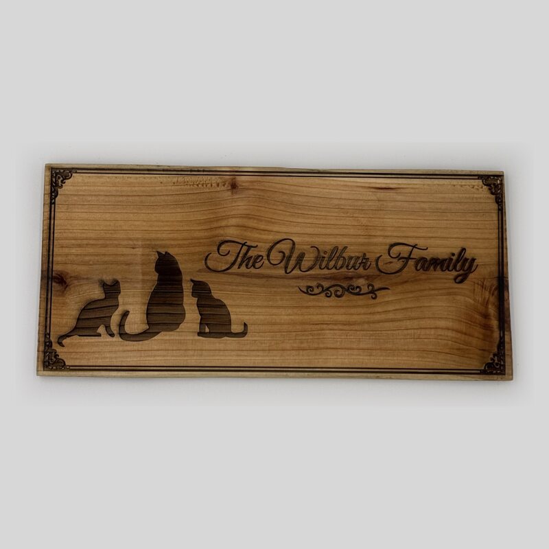 The Wilbur Family cedar sign with three cats and corner scrolls